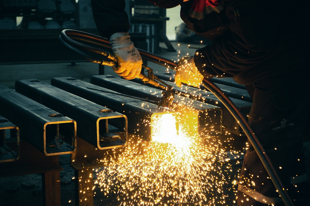 Welder working at a steel fabrication table; contextual shop image, not the Magswitch product