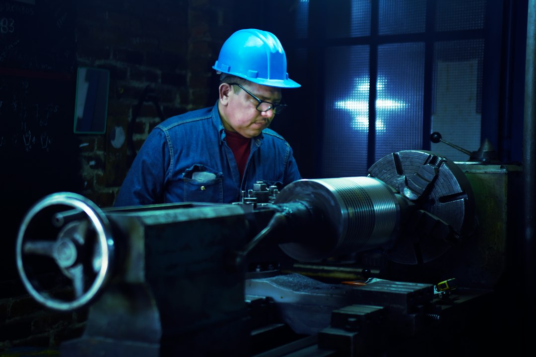 Industrial worker in a metalworking shop; contextual image for hearing-protection guidance.
