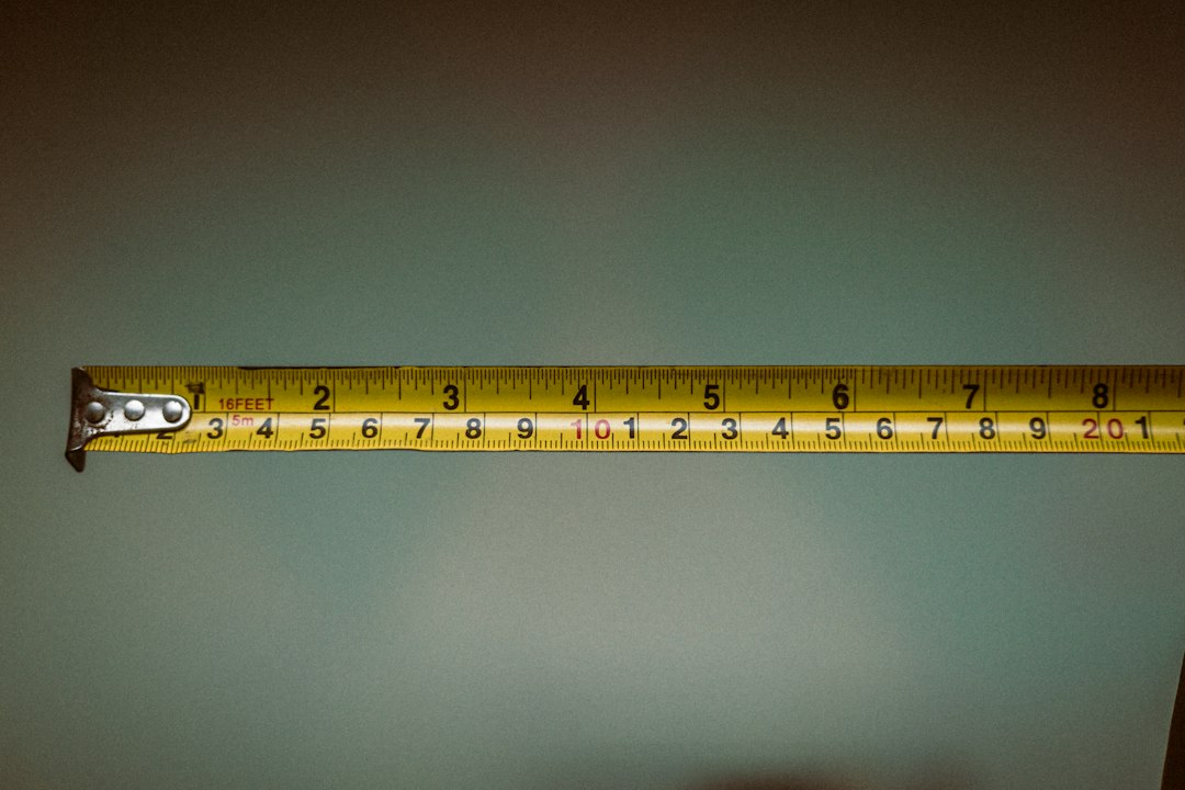 A person holding a tape measure; general measuring context, not the Klein 935DAG