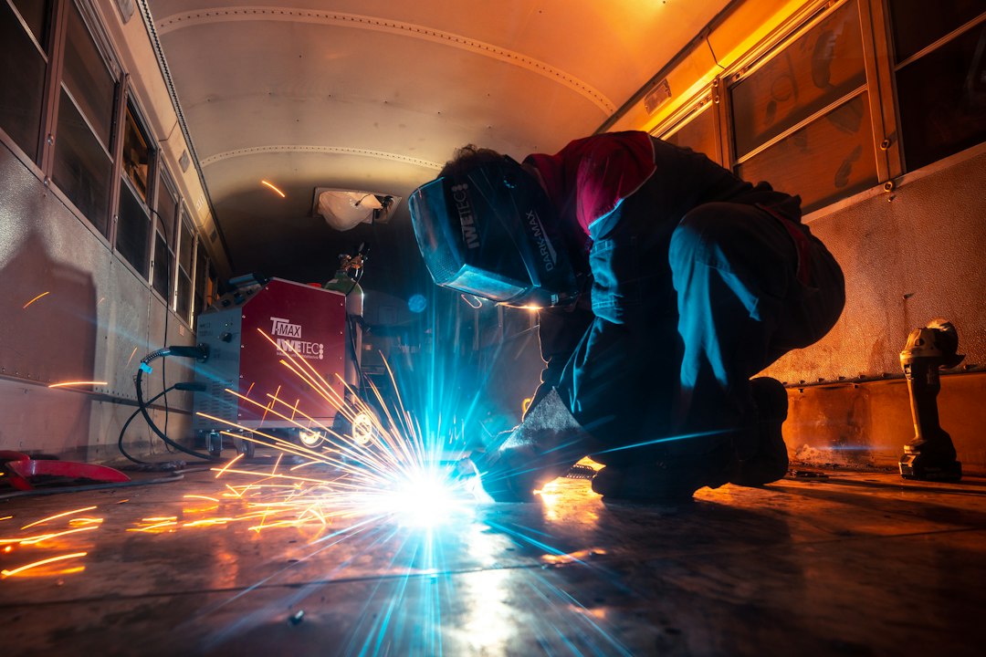 Welder working on metal in a fabrication shop; contextual image for ER410 and ER410NiMo filler selection.