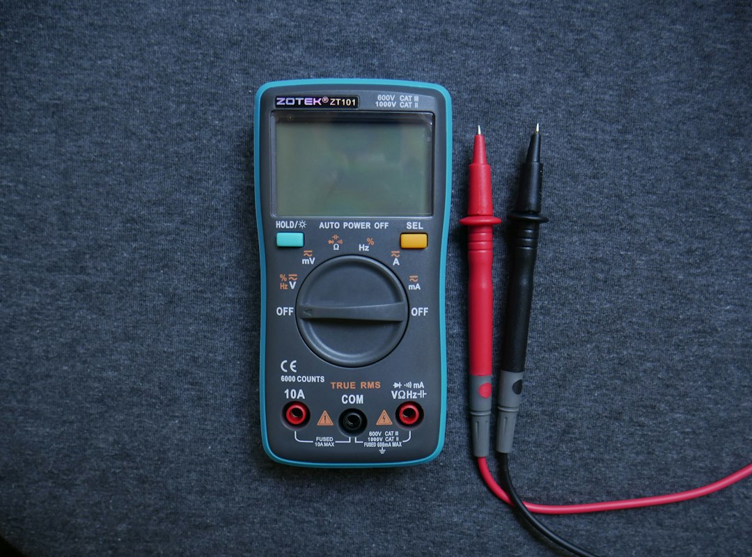 Digital multimeter on a workbench; contextual image for electrical testing in a welding shop, not a Fluke 117 product photo.