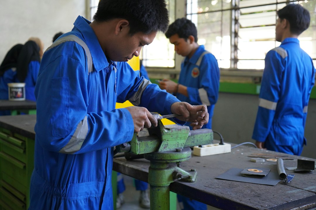 People working together on metal in a vocational shop training setting; contextual image for welding education